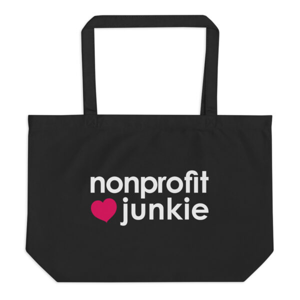 Large black organic tote bag, white text on one side says nonprofit junkie next to a pink heart