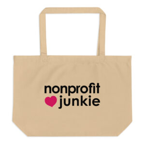 Large oyster organic tote bag, nonprofit junkie written out in regular arial like font next to a pink heart