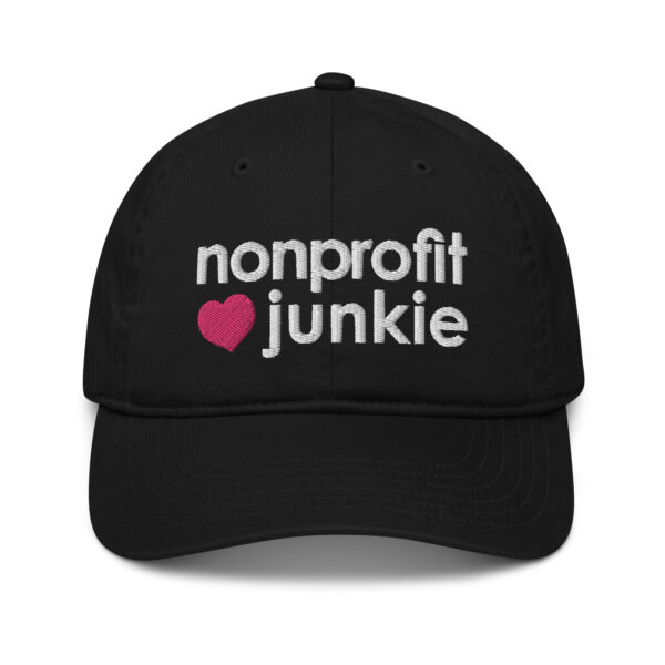 Black organic dad hat, white text on one side says nonprofit junkie in regular arial like font next to a pink heart