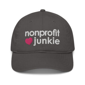 Charcoal organic dad hat, white text on one side says nonprofit junkie in regular arial like font next to a pink heart