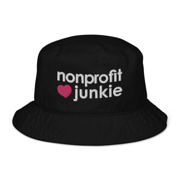 Black bucket hat, white text on one side says nonprofit junkie in regular arial like font next to a pink heart