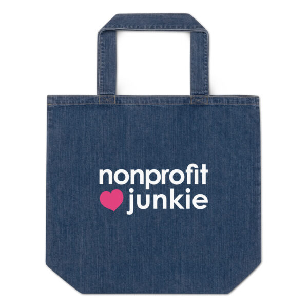 Organic denim tote bag, white text on one side says nonprofit junkie next to a pink heart