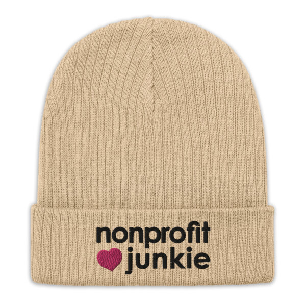 Beige ribbed knit beanie, black text on one side says nonprofit junkie in regular arial like font next to a pink heart