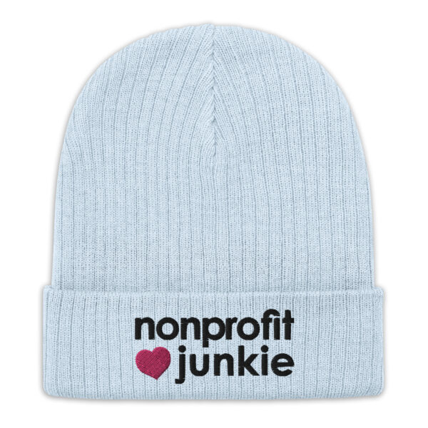 Light blue ribbed knit beanie, black text on one side says nonprofit junkie in regular arial like font next to a pink heart