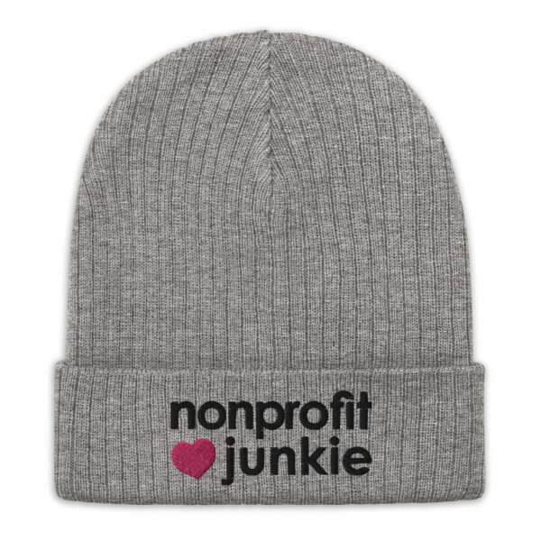 Light grey ribbed knit beanie, black text on one side says nonprofit junkie in regular arial like font next to a pink heart