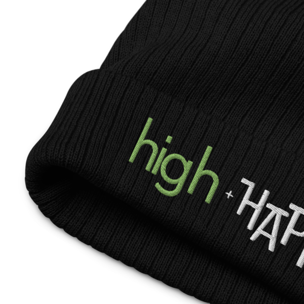 Black ribbed knit beanie, green and white text on one side says high + happy in regular arial like font