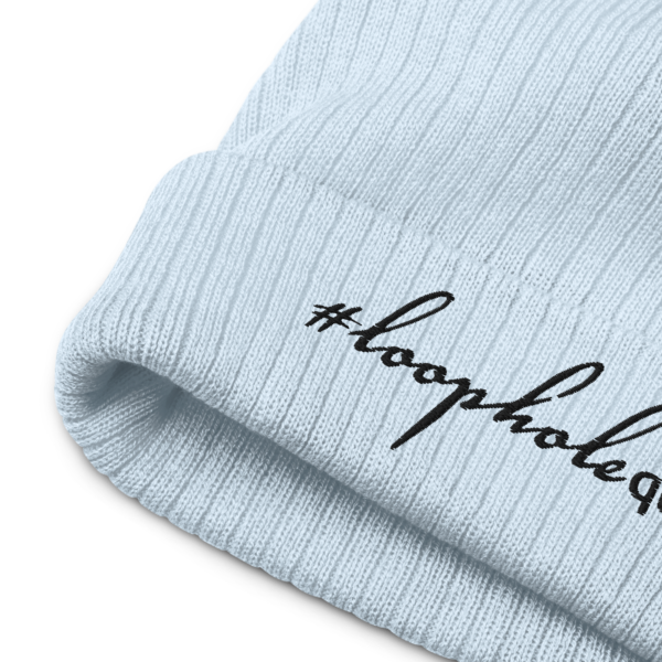 Light blue ribbed knit beanie, black text on one side says hashtag loophole queen written in italic cursive like font