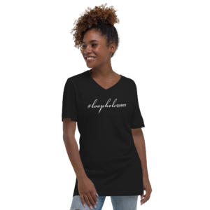Unisex black v neck tee, white text on one side says hashtag loophole queen in cursive like font and regular arial like font on a woman