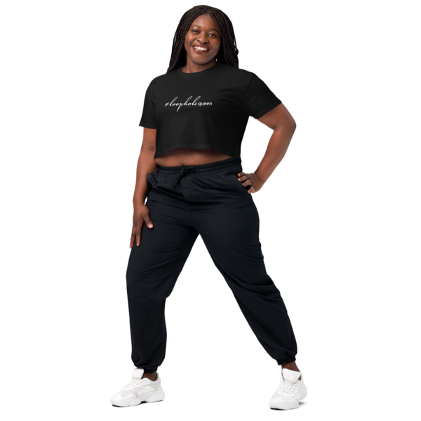 Womens black crop top, white text on one side says hashtag loophole queen in cursive like font and regular arial like font on a woman