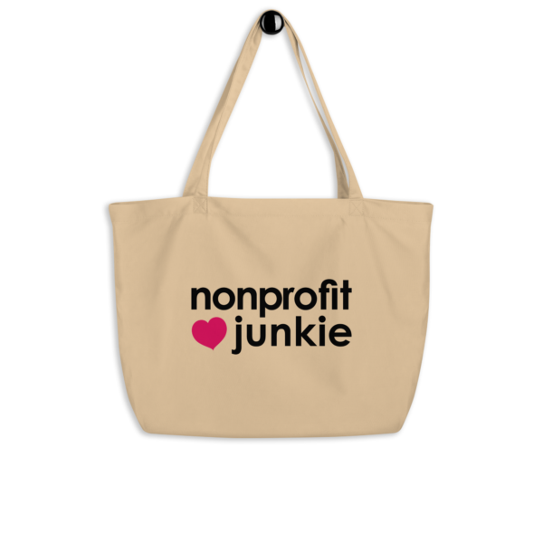 Large oyster organic tote bag, nonprofit junkie written out in regular arial like font next to a pink heart