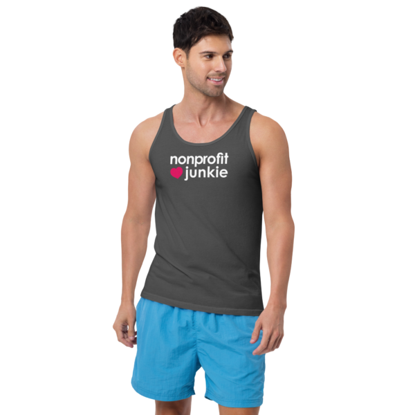 Unisex asphalt tank top, white text on one side says nonprofit junkie in regular arial like font next to a pink heart, on a man