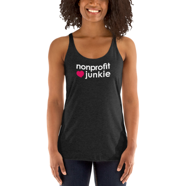 Womens vintage black racerback tank, white text on one side says nonprofit junkie next to a pink heart, on a woman