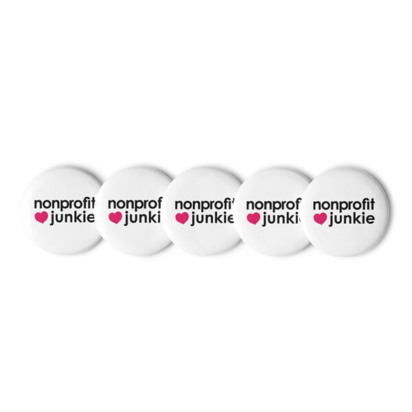 Set of white pin buttons, black text on one side says nonprofit junkie in regular arial like font next to a pink heart