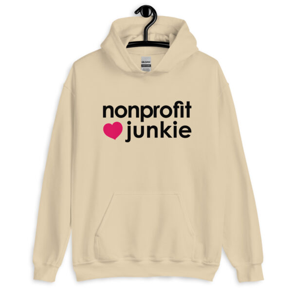 Unisex sand hoodie, black text on one side says nonprofit junkie in regular arial like font next to a pink heart