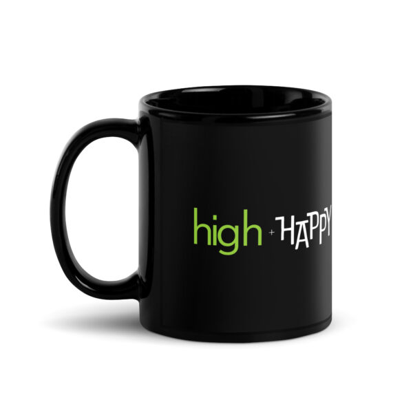 Black glossy 11 ounce mug handle on left side, white and green text around side says high + happy in regular arial like font and all capitalized arial like font