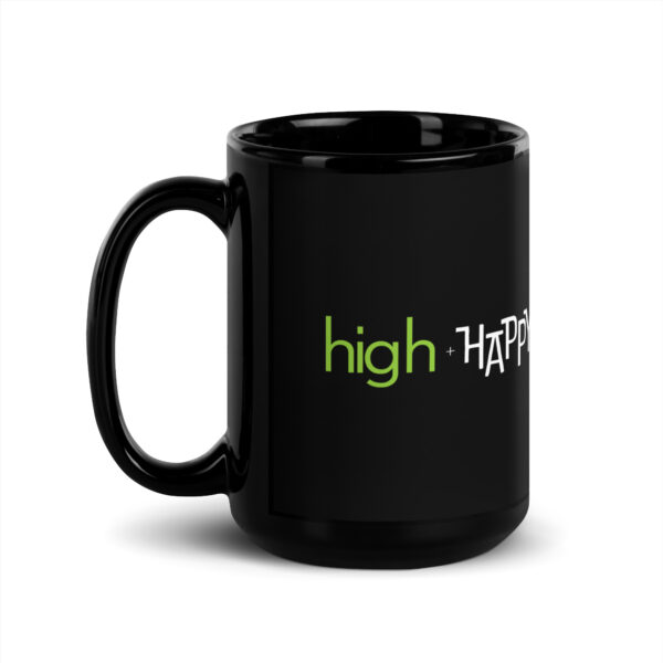 Black glossy 15 ounce mug handle on left side, white and green text around side says high + happy in regular arial like font and all capitalized arial like font