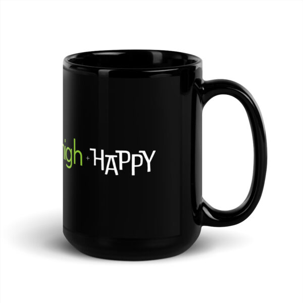 Black glossy 15 ounce mug handle on right side, white and green text around side says high + happy in regular arial like font and all capitalized arial like font