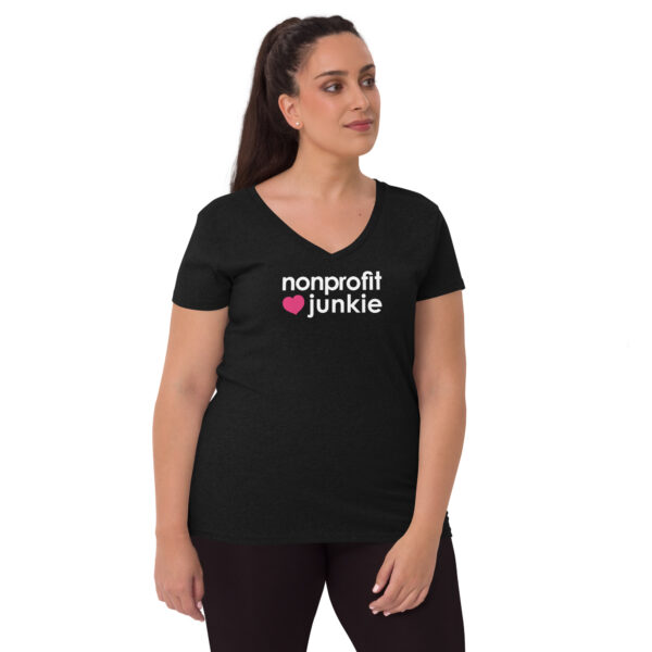 Womens black recycled v neck t shirt, white text on one side says nonprofit junkie in regular arial font next to a pink heart on a woman