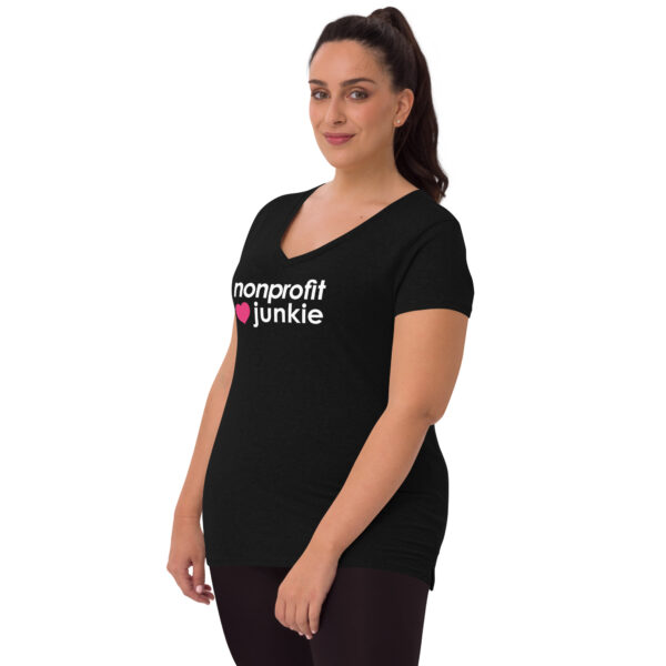 Womens black recycled v neck t shirt, white text on one side says nonprofit junkie in regular arial font next to a pink heart on a woman