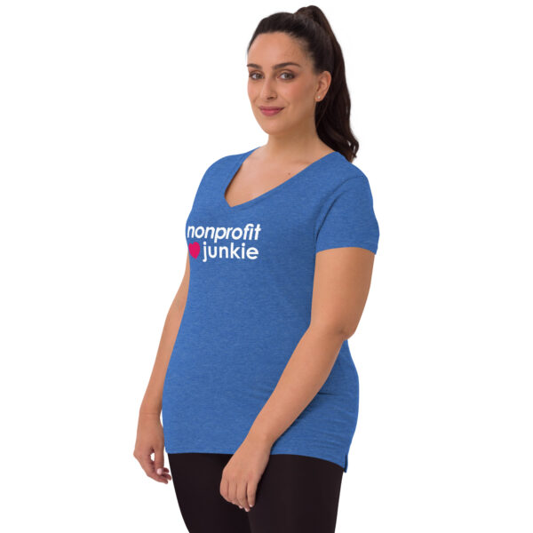 Womens heather blue recycled v neck t shirt, white text on one side says nonprofit junkie in regular arial font next to a pink heart on a woman