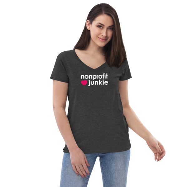 Womens charcoal heather v neck t shirt, white text on one side says nonprofit junkie in regular arial font next to a pink heart