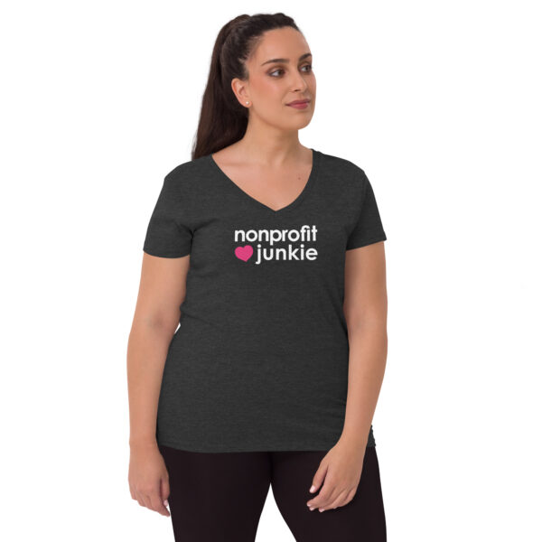 Womens charcoal heather recycled v neck t shirt, white text on one side says nonprofit junkie in regular arial font next to a pink heart on a woman