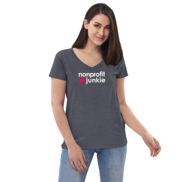 Womens heather navy v neck t shirt, white text on one side says nonprofit junkie in regular arial font next to a pink heart