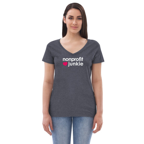 Womens heather navy v neck t shirt, white text on one side says nonprofit junkie in regular arial font next to a pink heart