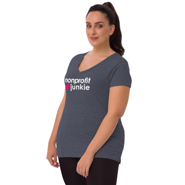 Womens heather navy recycled v neck t shirt, white text on one side says nonprofit junkie in regular arial font next to a pink heart on a woman